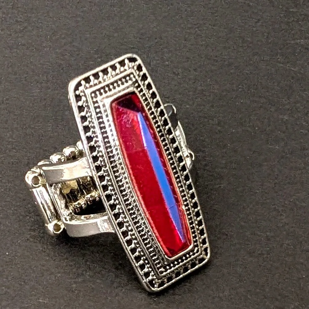 Orangey red glass ring with center bright blue stripe stretch ring